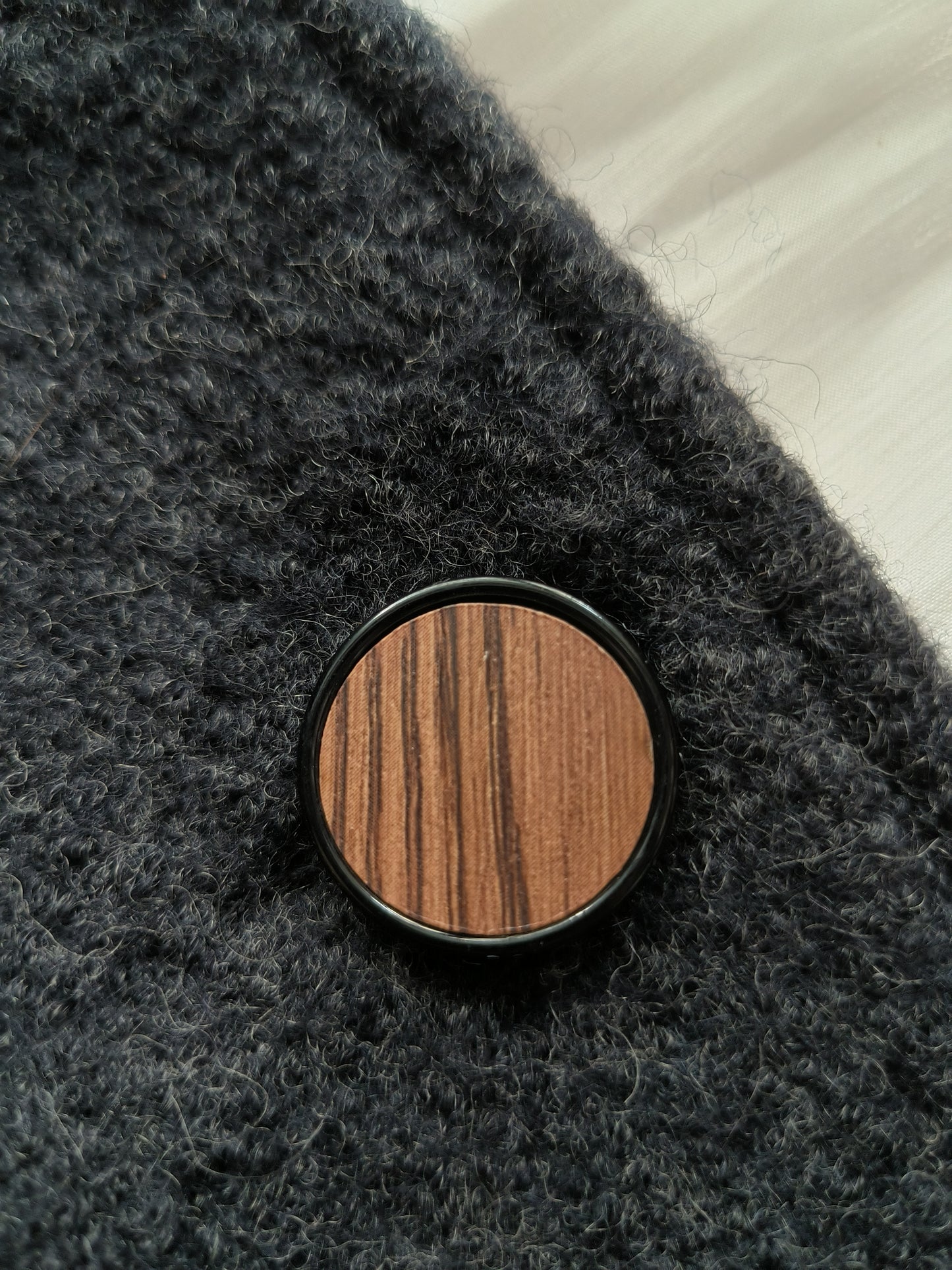 Round button in wood-like material